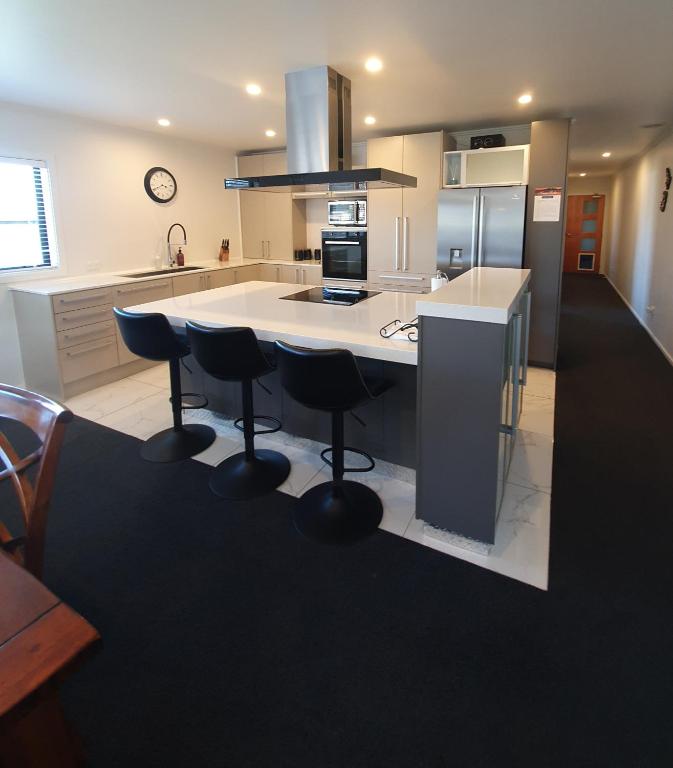 From the main living area, the hall leads to the second bedroom & bathroom.  Through the timber door is the large garaging & access to the third bedroom